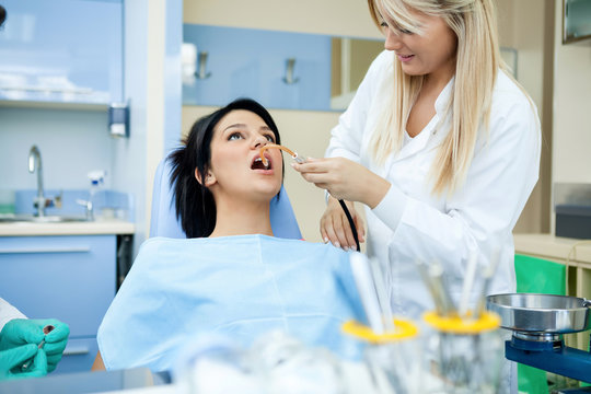 Dentists assisting a female patient