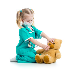 child girl dressed as doctor playing with toy