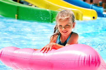 Child on water slide at aquapark.