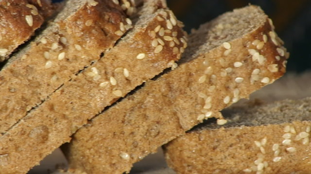 The close-up of rye-bread cutting.