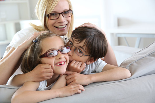Woman and children with eyeglasses on