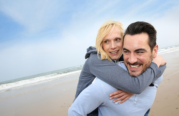 Middle-aged couple having fun on a sandy beach