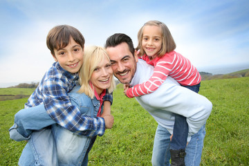 Portrait of happy family in countryside