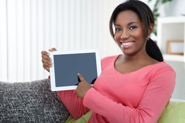 Woman pointing at empty  tablet screen