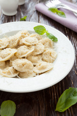 round meat ravioli with grated parmesan cheese