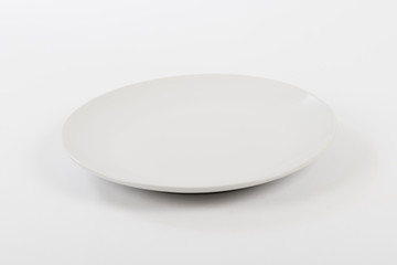 Empty white plate on a white background.