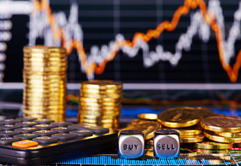 Dices cubes with the words SELL BUY golden coins, calculator and