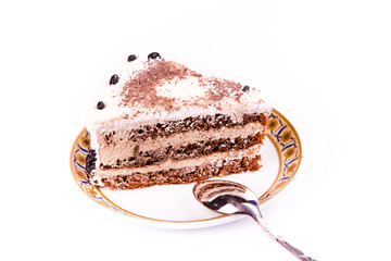 A piece of tasty coffee chocolate cake on a plate with a spoon