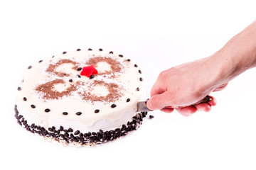 Male hand cutting a piece of tasty coffee chocolate cake