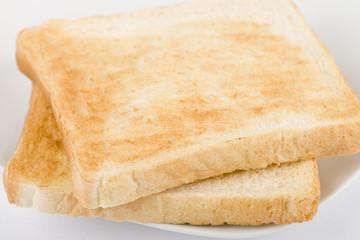 Simple Toast - Toasted sliced bread on a white background.