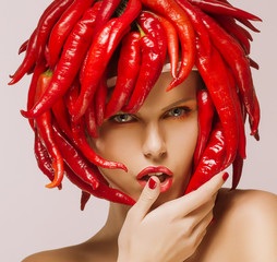 Hot Chili Pepper on Shiny Woman's Face. Creative Concept