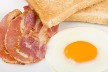 Fried egg, Bacon & Toast. Breakfast meal.