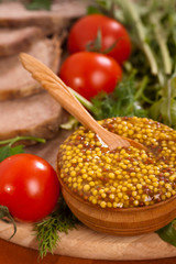 Mustard with wooden spoon