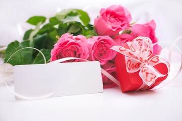 Roses and gift box with a card