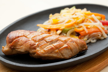 Grilled chicken breasts and noodles