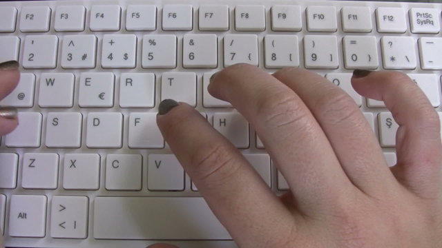 Hand typing on keyboard time lapse