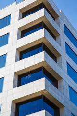 Corner of White Marble Building with Blue Glass Windows
