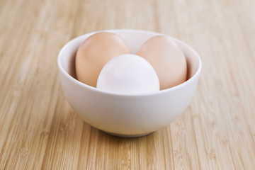 Whole Organic Eggs in White Bowl