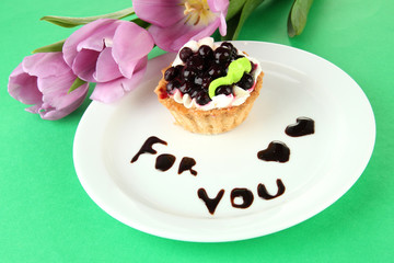 Sweet cake with blackberry and chocolate sauce