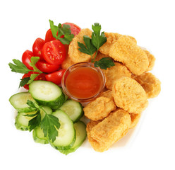 Fried chicken nuggets with vegetables and sauce isolated