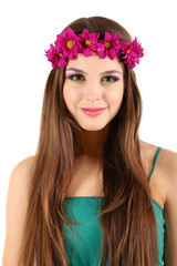 Young beautiful girl in green dress with bright wreath