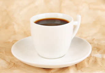 Cup of strong coffee on beige background
