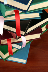 Many books with bookmarks on brown background