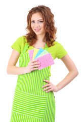 Young woman wearing green apron with cleaning sponges, isolated