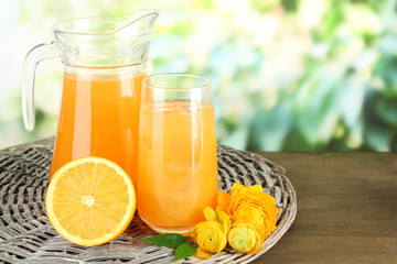 Glass and pitcher of orange juice