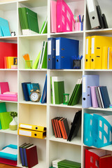 White office shelves with different stationery, close up