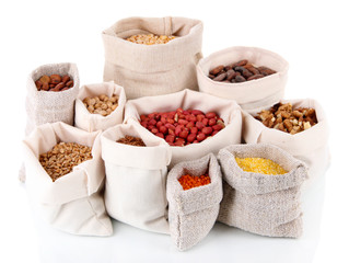 Different kinds of beans in sacks isolated on white