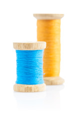 two bobbins with sewing thread