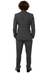 Back pose of a man in gray formals