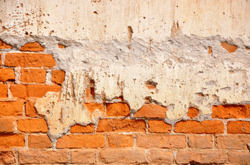 Red clay stained on the white exposed brick concrete wall.
