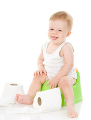 funny baby boy on chamber pot. isolated on white