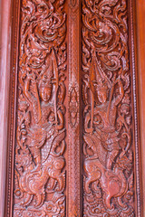 Fototapeta na wymiar Ornament wooden door of Thai temple in Chiangmai, Thailand