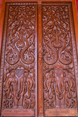 Ornament wooden door of Thai temple in Chiangmai, Thailand