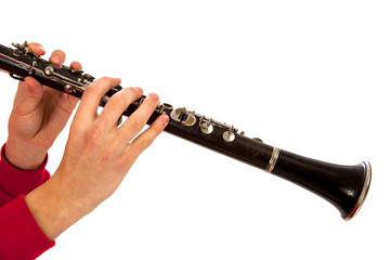 Hands playing on clarinet. Isolated over white background