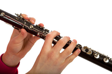Hands playing on clarinet. Isolated over white background