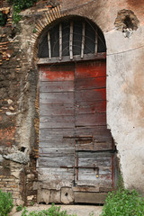 Casale of Vaccareccia - a brown wood old door in Appia Antica, R
