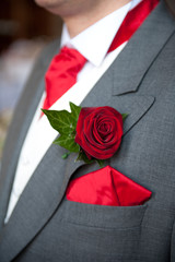 groom red rose buttonhole wedding