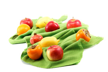 Set of different fresh fruits on green cloth.