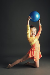 Beautiful girl gymnast with a ball