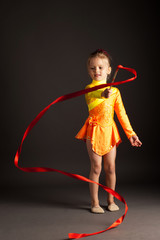 little girl doing rhythmic gymnastics with ribbon