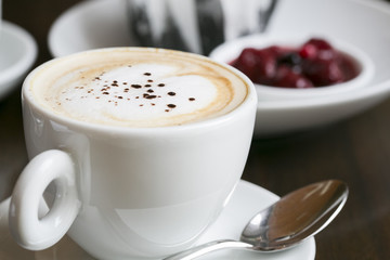 Coffee in a white ceramic cup on a Wooden Table