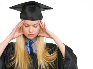 Portrait of stressed young woman in graduation gown