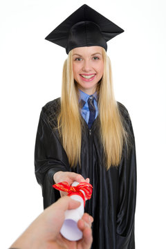 Smiling Young Woman In Graduation Gown Receiving Diploma