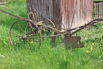 old rusty plow to work the land in Meadow Green