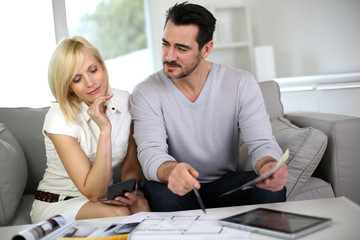 Couple looking at paint colors for new home