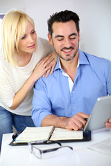 Middle-aged couple working from home